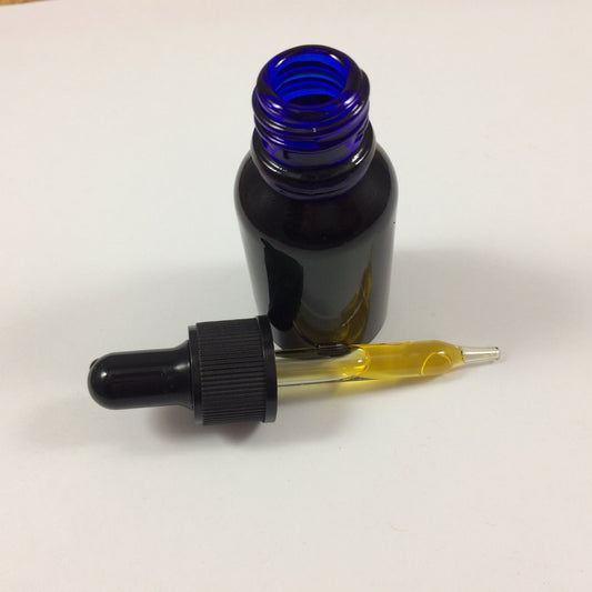 A small dark amber glass dropper bottle with a blue cobalt neck, shown with a black dropper pipette containing yellow liquid on a plain white surface.