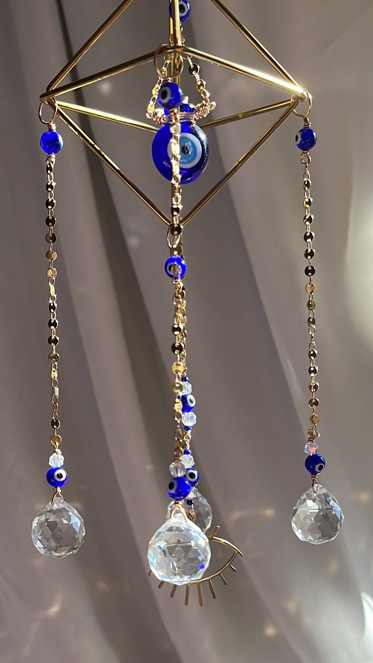 Decorative hair accessory with crystals and gold elements on a white surface